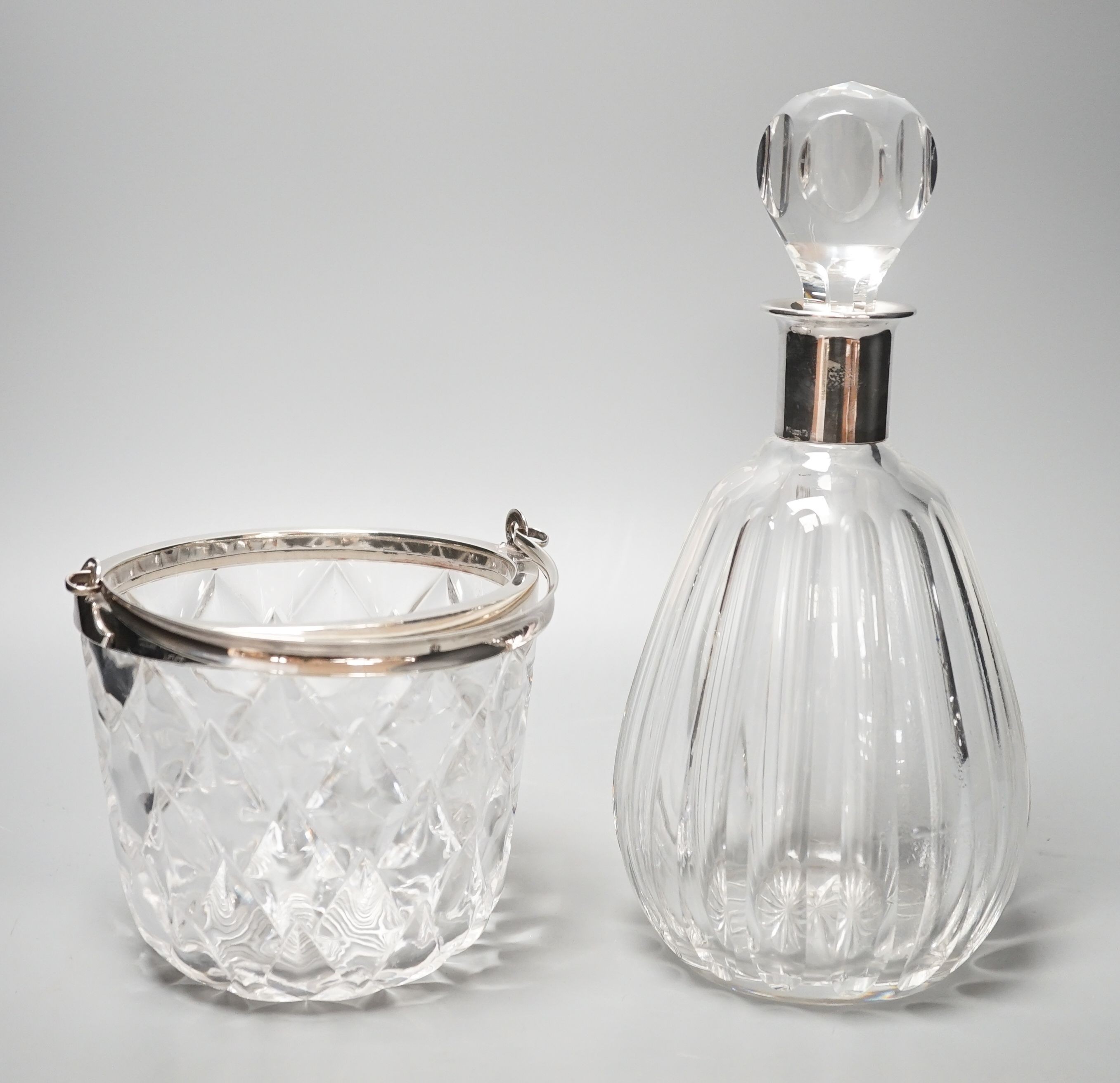 A German 835 white metal mounted glass decanter and a late Victorian silver mounted glass vase with handle.